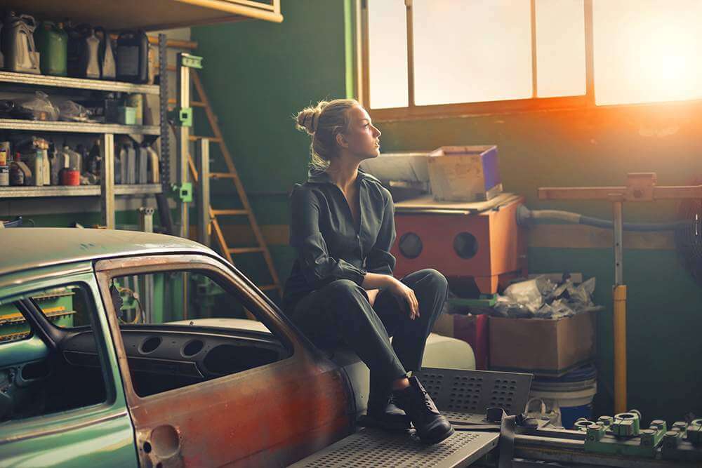 Woman in garage piled with stuff