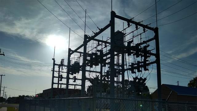 electrical substation against dark blue sky